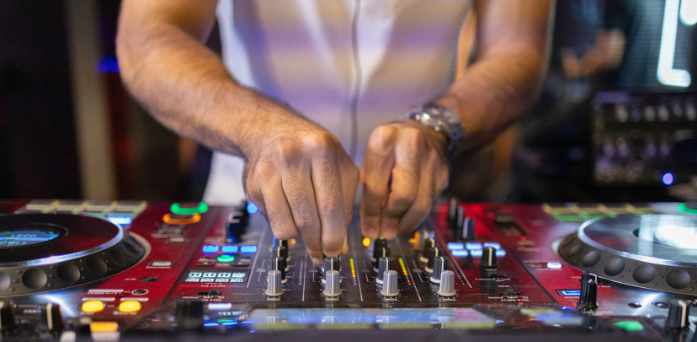 Party DJ mixing at gig.